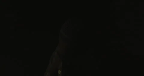 Mic surfaces, brightens, elegantly disappears into black Stock Footage 246962097