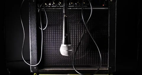 Mic swing back and forth in front of amp isolated on black Stock-Footage 204959912