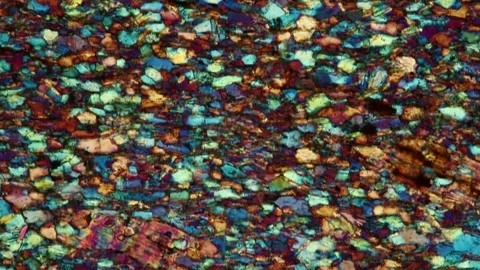 Micaschist thin section of stone under the microscope in polarized light Stock Footage 344310846