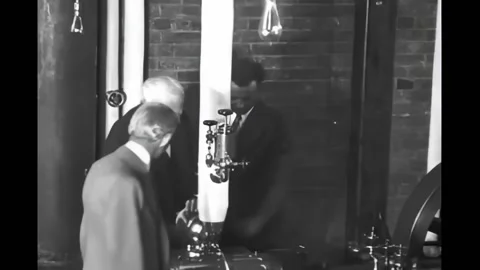 MICHIGAN - 1928 - Thomas A. Edison operates a steam engine in the laboratory, Stock Footage 296692064