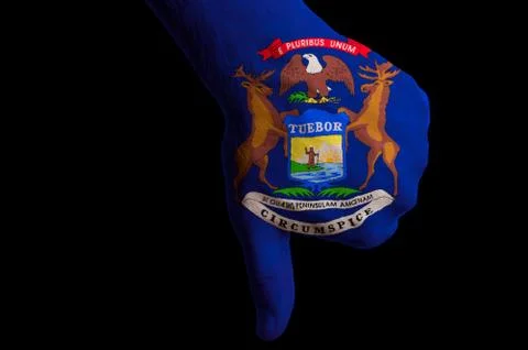 Michigan us state flag thumbs down gesture for failure made with hand Stock Photos