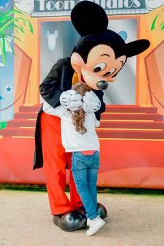 Mickey hugging child Stock Photos
