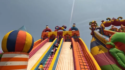 Mickey Mouse Slider Rides, toddlers climb up and slide down the sides Stock Footage 249875915