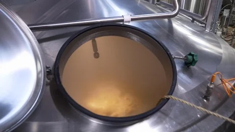 Micro-brewery beer-making process in large stainless steel vat. Stock Footage 100650297