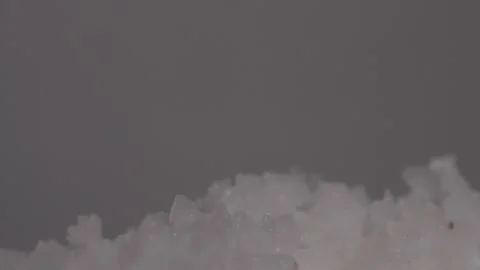 Micro Close-Up of Salt Crystals Falling Onto a Pile of Salt Grains Stock Footage 313062751