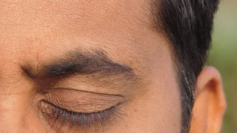 Micro close shot of an indian man opening eye after meditation Stock Footage 148426270