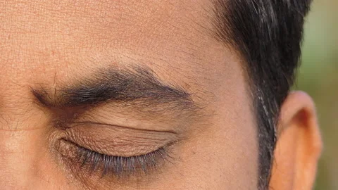 Micro close shot of an indian man meditating with eyes closed Stock Footage 148426683