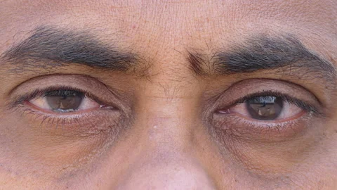 Micro close shot of an indian man opening eye after meditation Stock Footage