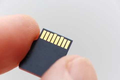 Micro DS flash drive held between fingers for easy handling Stock Photos