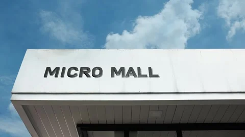 Micro mall word sign displayed on building with blue sky background Stock Footage 318756748