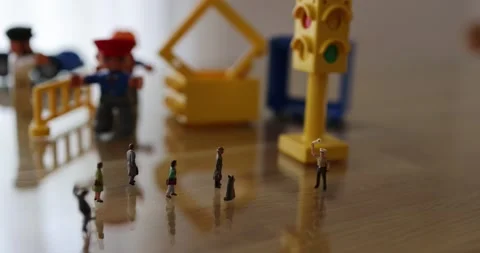 Micro people on the desk in a street like environment Stock Footage 270460394