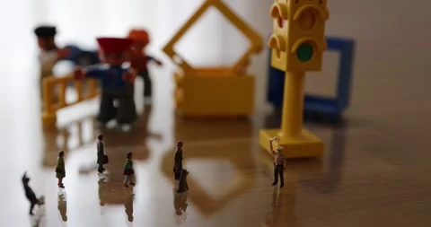 Micro people on the desk in a street like environment Stock Footage 270460415