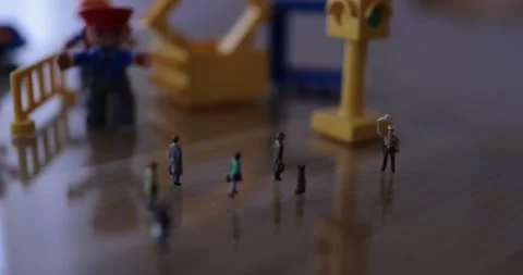 Micro people on the desk in a street like environment Stock Footage 270460425