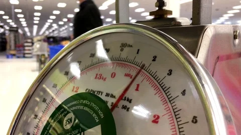 Micro of people weighing on scale inside Walmart store with 4k resolution 스톡 동영상 70657885