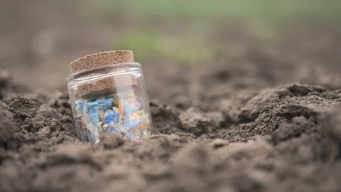Micro plastic fragments found in the soil. Stock Photos