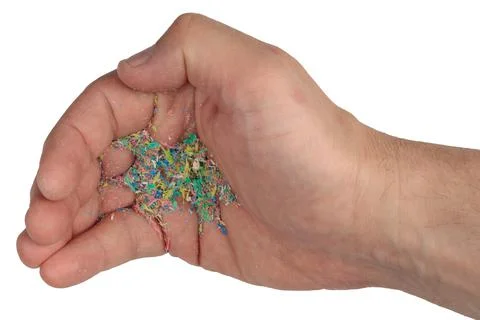 Micro plastic on the hand, an exisolated background. The environmental proble Stock Photos