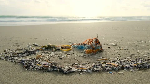 Micro plastics debris pollution on dirty sea coast ecosystem,environmental waste Stock Footage 231530464