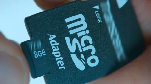 A micro SD card is inserted into the SD adapter Stock Footage 130420153