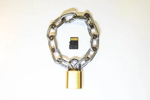 Micro SD card is protected by a lock with a chain 库存照片