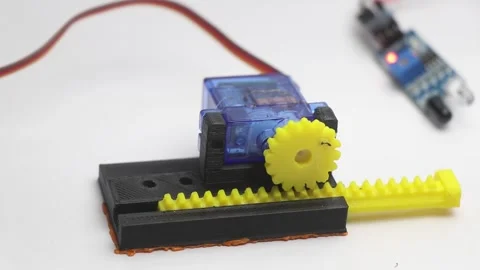 Micro servo motor with its shaft connected to 3d printed gears and slider Stock Footage 315307071
