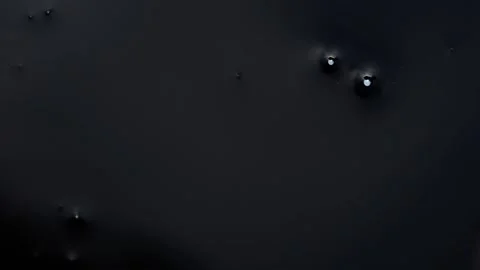 Micro shot of instant drop of black ink on white background Stock Footage 147700819