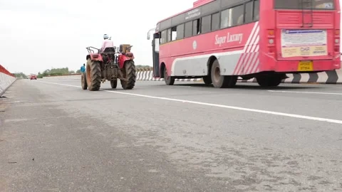 Micro shot of man driving tractor, Red color tractor Video stock 156990611