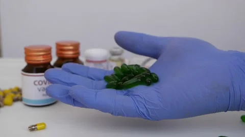 Micro shot of opening hand with green tablets holding Stock-Footage 147697484