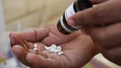 Micro shot of taking out tablets over another hand, close view of white color Video stock 147696952