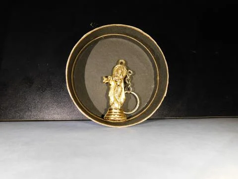 Micro statue of Lord Krishna inside a black circle Stock Photos