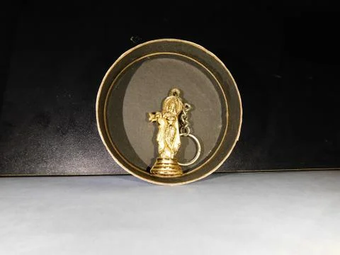 Micro statue of Lord Krishna inside a black circle Stock Photos