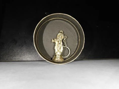 Micro statue of Lord Krishna inside a black circle Stock Photos