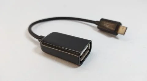 Micro USB OTG cable, black, close up, white background Stock Photos