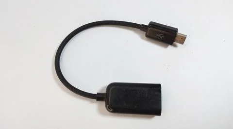 Micro USB OTG cable, black, close up, white background Stock Photos
