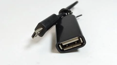 Micro USB OTG cable, black, close up, white background Stock Photos