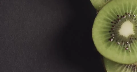 Micro video of close up of kiwi fruit slices with copy space on black background Stock Footage 331246530