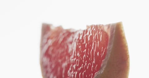 Micro video of close up of slice of red grapefruit with copy space on white Stock Footage 331246528