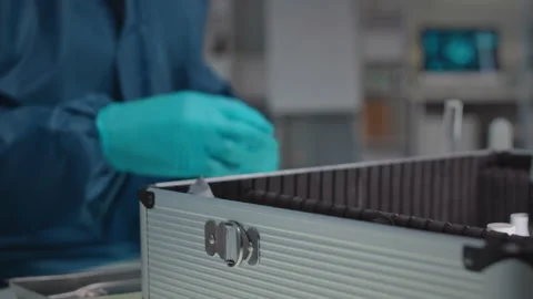 Microbiologist Opening Case with Radioactive Samples in Lab Video stock 234982197