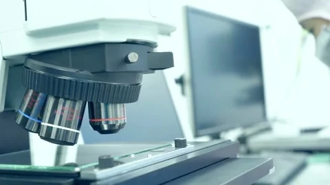 A microbiologist studies a sample of bacteria under an electron microscope, Stock Footage 336582689