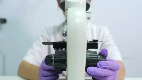 Microbiologist is testing a sample of blood contaminated by Coronavirus Covid-19 Stock Footage 140388577