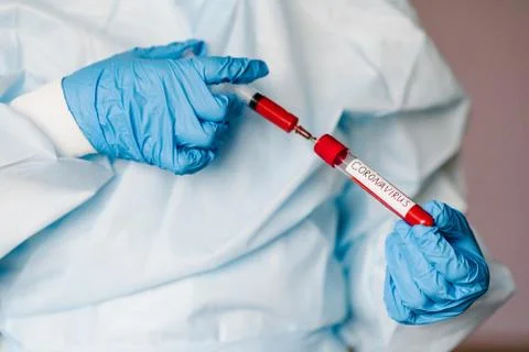 Microbiologist testing a tube with biological sample, syringe with blood cont Stock Photos