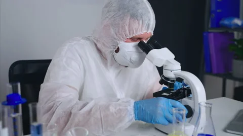 Microbiologist is viewing new virus or bacteria in microscope, working in Stock-Footage 158387775