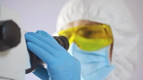 Microbiologist working with microscope Stock Footage 106216931