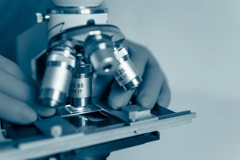 Microbiologist working with optical microscope Stock Photos