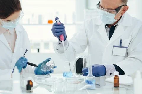 Microbiology scientists are working on creating a new vaccine. Stock Photos
