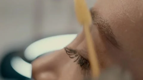 The microblade master combs the eyebrow after finishing the microblading work. Stock Footage 223158159