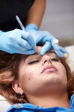 Microblading close up, eyebrow adding pigment into skin. Stock Photos