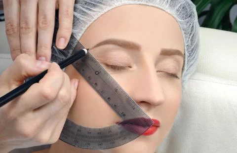 Microblading. Cosmetologist making permanent makeup. Woman getting facial car Stock Photos
