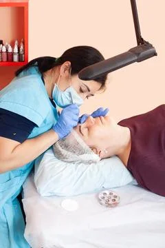 Microblading in a cosmetologist's studio - Permanent eyebrow makeup 写真素材