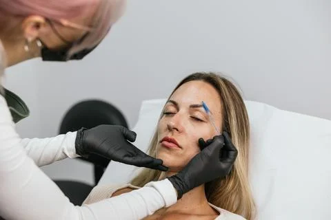 Microblading eyebrow tattoo procedure in progress Stock Photos