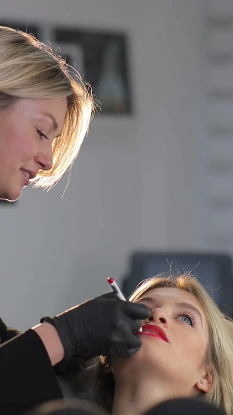 Microblading lip tattooing with a special coloring pigment corrects the color of Stock Footage 263007579